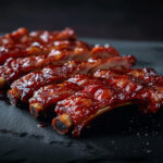 Welcome-&-Our-Food-Small-lcartwork_Chinese_spare_ribs_set_against_a_dark_background._A_s_456527f1-ae46-4d8b-8dc5-b9192f55350d Welcome-&-Our-Food-Small-lcartwork_Chinese_spare_ribs_set_against_a_dark_background._A_s_456527f1-ae46-4d8b-8dc5-b9192f55350d